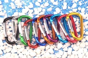 Colorful set of D-ring aluminum alloy carabiners shown in ten vibrant colors on blue stones