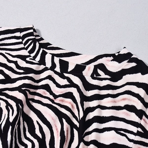 Detail of zebra print dress neckline with pink dye accents on soft knit fabric