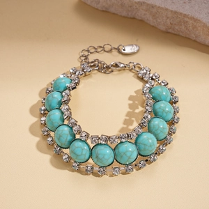 Detailed close-up of blue resin beaded bracelet with crystal accents and lobster clasp