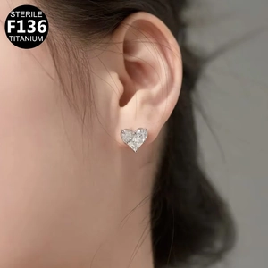 Close-up of heart-shaped F136 titanium labret stud earring on ear with zircon inlay