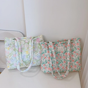 Detail of floral quilted cotton tote bags showing soft diamond stitching and patterns