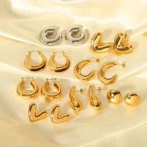 Minimalist 18K gold and silver stainless steel heart earrings set on silk