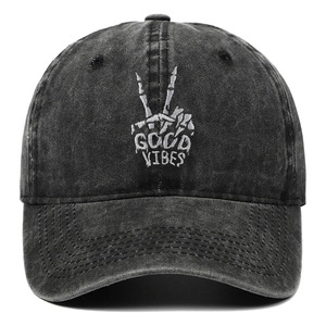 Detailed close-up of Good Vibes skeleton hand embroidery on washed cotton baseball cap