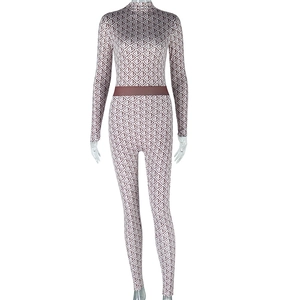 Macro detail of high-collar bodysuit with pink and brown geometric pyramid patterns
