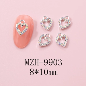 Macro shot of 8x10mm hollow heart nail charms with AB rhinestones on a manicure