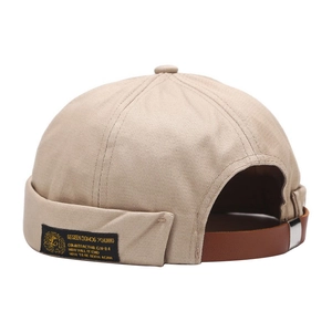 Khaki docker hat with twill texture featuring side woven label and leather back strap