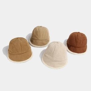 Detail of winter corduroy fisherman hats showing fleece lining and four earth-tone colors