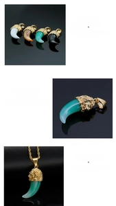 Detail of gold-plated lion head pendants with resin tusks in four colors and stainless steel