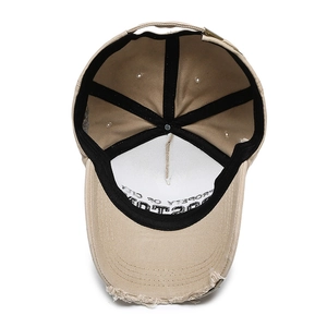 Distressed khaki denim baseball cap with side letters and interior stitching details