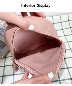 Interior view of small pink faux leather backpack with monogram print and gold zipper