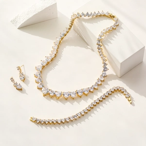 Elegant gold heart jewelry set including zircon necklace bracelet and stud earrings