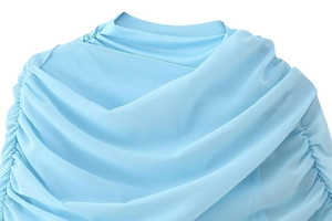 Detailed close-up of light blue mesh fabric with elegant pleated textures and ruched details