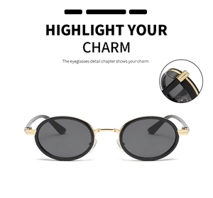 Detailed view of vintage oval sunglasses with metallic nose bridge and black lenses