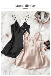 Flat lay of satin V-neck nightgowns in black and champagne pink on a plush rug