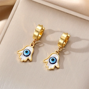 Macro shot of gold Hamsa Hand earrings with blue evil eye detail and clasp