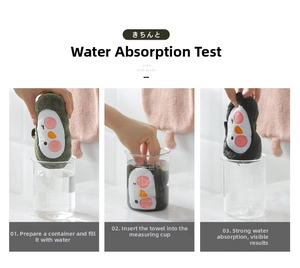 Water absorption test showing thick cartoon penguin coral fleece hand towel absorbing liquid