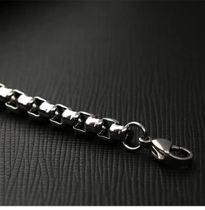 Sleek silver stainless steel box chain bracelet with lobster clasp on black leather