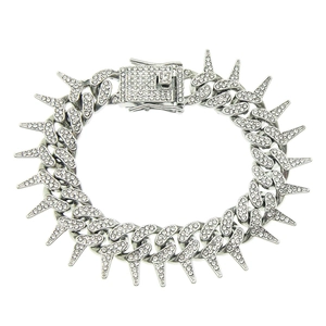 Close-up of silver Cuban link bracelet with iced-out rhinestones and punk style spikes