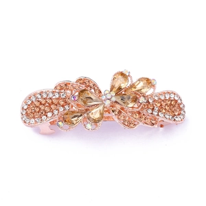 Detailed view of rose gold alloy hair clip featuring champagne and clear rhinestones