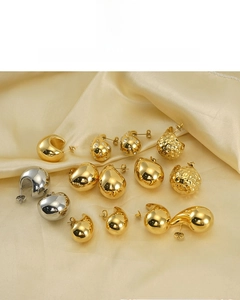 Detail of assorted 18K gold and silver plated water drop earrings on silk fabric