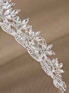 Close-up of bridal crown featuring leaf design and marquise rhinestones in silver finish