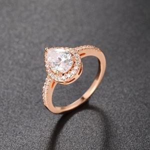 Detailed view of pear-shaped halo ring in rose gold with micro-pave cubic zirconia