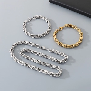 Detail view of twisted chain jewelry set with gold and silver necklaces and bracelet