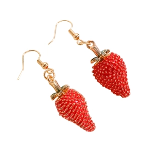 Detalle de pendientes de fresa roja con hojas verdes y textura realista de fruta