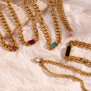 Detailed macro view of 18K gold plated Cuban chain necklaces with colorful zircon stones