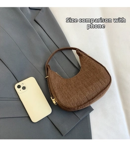 Brown hobo bag with crocodile texture shown next to a smartphone for size comparison