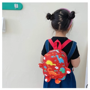 Detailed back view of a child wearing a red backpack with colorful dinosaur patterns