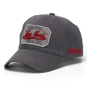 Detailed close-up of New York embroidery on dark grey cotton twill baseball cap