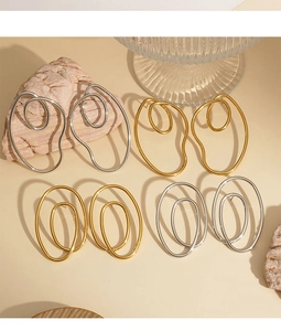 Collezione dettagliata di orecchini a spirale in acciaio inossidabile in oro e argento
