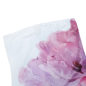 Detailed macro view of pink and purple floral print on elegant strapless dress fabric