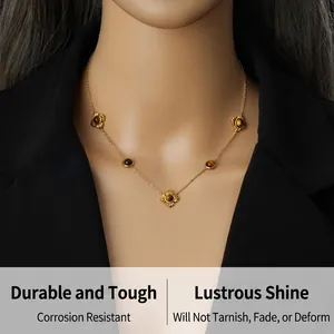 Macro view of gold-plated stainless steel flower necklace with tiger eye stone on a model