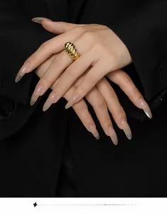 Detail shot of a golden croissant dome ring featuring a textured wavy ribbed design