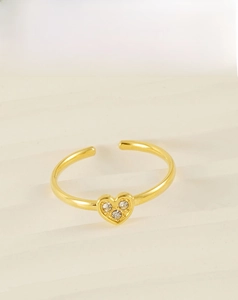 Macro detail of 18k gold plated stainless steel heart ring with white zircon stones