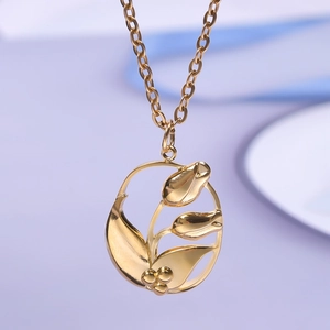 Macro detail of a golden stainless steel tulip flower pendant with hollow oval frame