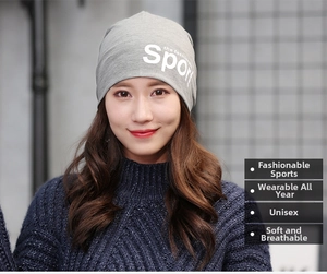 Detail view of a grey knitted beanie with Sport the fashion logo and ribbed texture