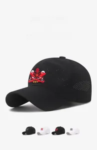 Detail of red Chinese lion embroidery on breathable black mesh sun hat for summer