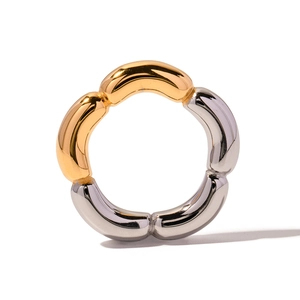 Detail of two-tone gold and silver plated ring with segmented bean-shaped design