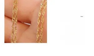 Detail of a 18k gold plated water wave chain necklace with elegant twisted texture