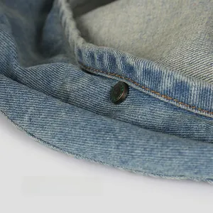 Detailed close-up of light blue washed denim beret featuring vintage metal hardware