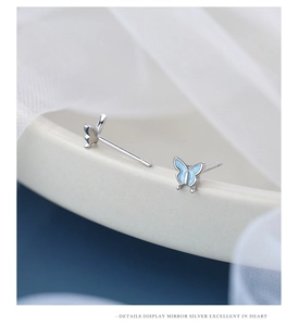 Macro shot of S925 sterling silver butterfly studs with sky blue enamel details