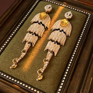 Vintage gold drop earrings with pearls and waterdrop crystals on green velvet