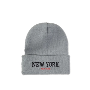 Close-up of grey knit beanie featuring black New York embroidery and detailed texture