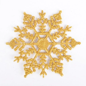 Gros plan d'un flocon de neige doré pailleté de 10 cm pour la décoration de Noël et couronnes