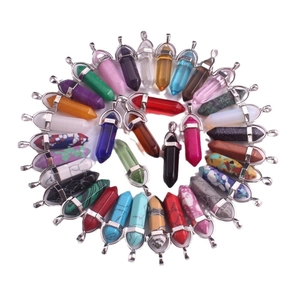 Natural hexagonal crystal prism pendants set with silver metal clasps on white background