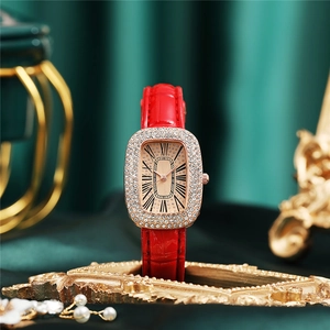 Detail of luxury ladies watch with red leather strap and diamond bezel on vintage frame