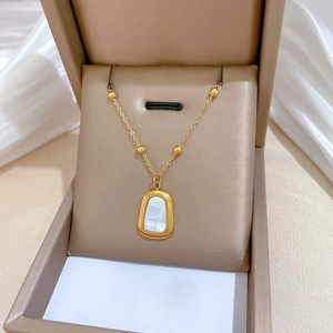 Gold titanium steel necklace with square white shell pendant in a beige jewelry gift box